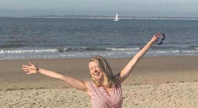 Iris arms wide on beach
