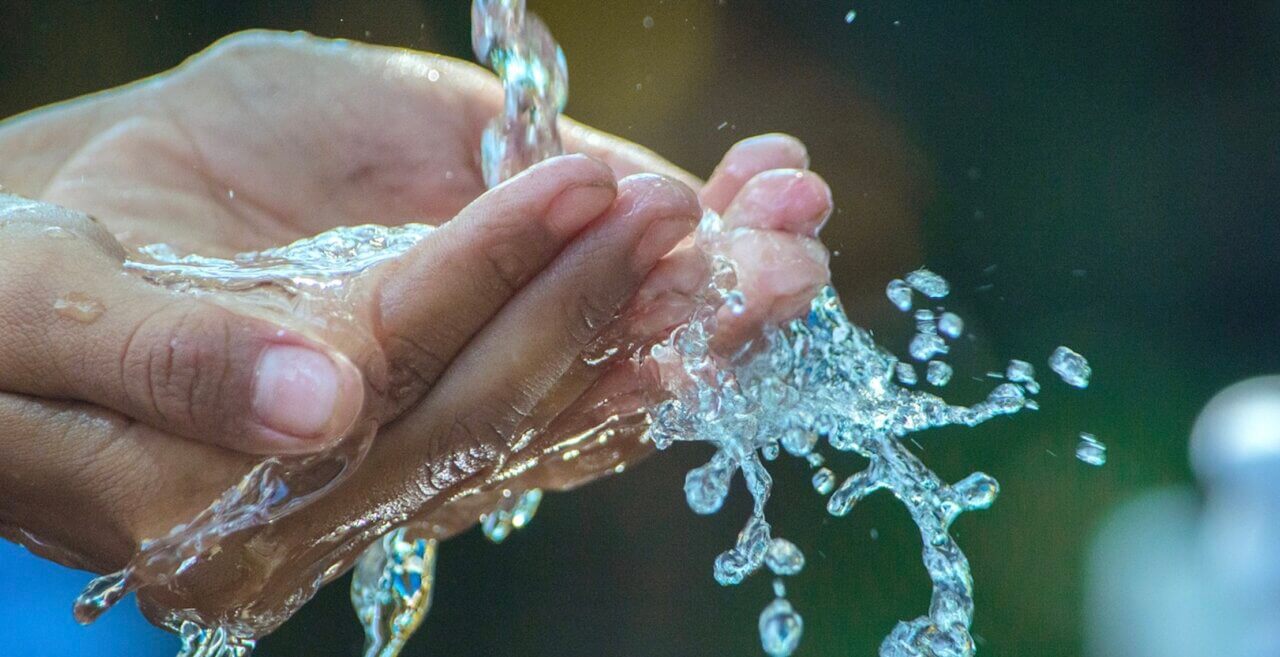 cupped hands with water
