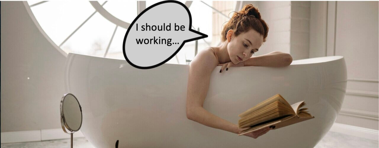 Woman in bath reading book